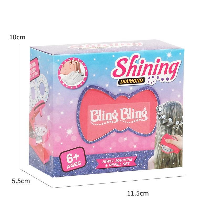 The Fashiongirl Bling Bling Ultimate Glam Kit includes 180 diamonds, a styling tool, and is designed for ages 6+. Features bow design, product images, and packaging dimensions of 10 x 11.5 x 5.5 cm.