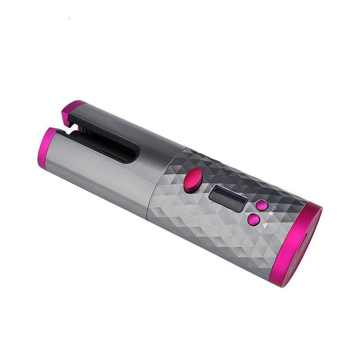The Fashiongirl Cordless Automatic Hair Curler features a metallic gray, diamond-textured body with bright pink accents, side buttons, and a small digital display for effortless styling anywhere.