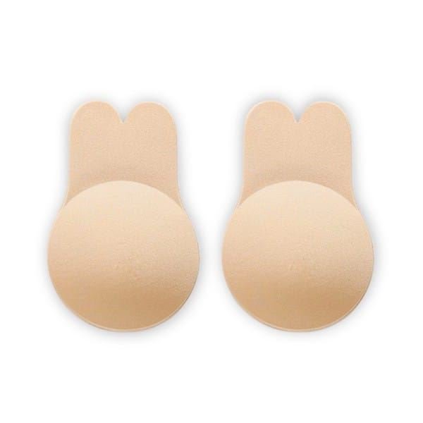 Shapelux Lifting Pads for Invisible Breast Lift—beige, round adhesive pads with bunny ear-shaped tabs—offer a strapless bra alternative and strong hold, displayed on a white background.