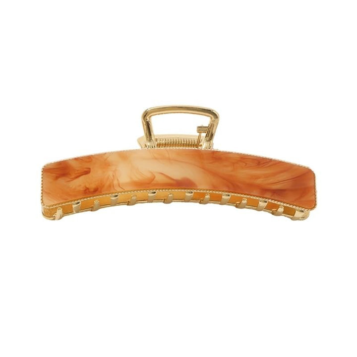 The SOHO Abby Hair Claw - Ginger by SOHO features a marbled orange and beige design with a rectangular shape and interlocking teeth, offering a secure hold for everyday use.