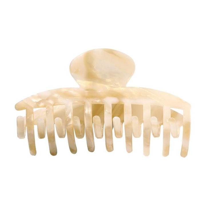 The SOHO Gaja Hair Claw in Beige Marble features wide, curved prongs and a rounded top for effortless style, shown here against a white background.