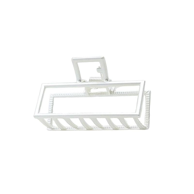 The SOHO Kai Small Metal Hair Claw in matte silver features a sturdy spring hinge and geometric open-frame design, offering a secure hold. Perfect for those who prefer metal hair clips over plastic ones.