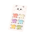 The SOHO Lala Mini Hair Claws - Pastel Flowers by SOHO feature six pastel floral hair claws in pink, yellow, purple, blue, orange, and green, presented on a card with a cute cat face illustration.
