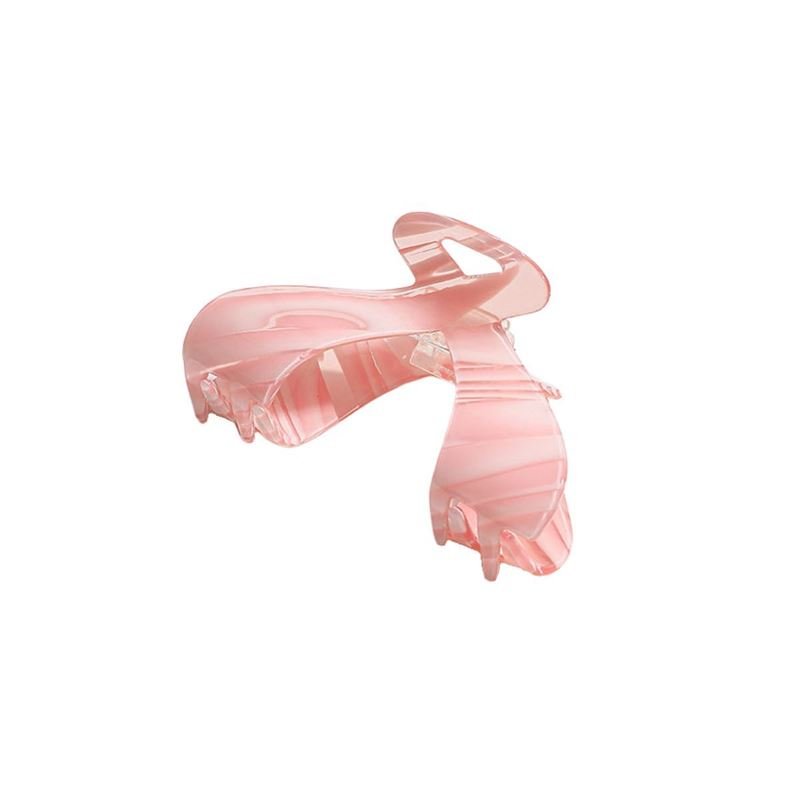 The SOHO Malou Hair Claw - Pink by SOHO features a curved, butterfly-inspired design with a pink marbled finish, shown against a plain white background.