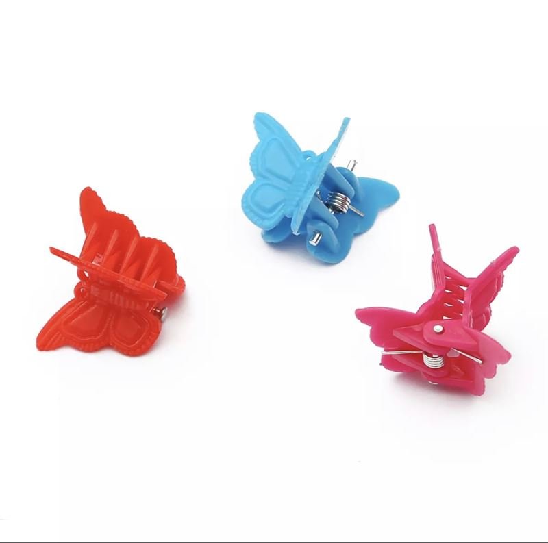 Fifty SOHO Mini Butterfly Hair Claws in assorted multicolours are displayed on a white background. Made of plastic with metal spring centers, these fun SOHO hair accessories add vibrant flair to any hairstyle.