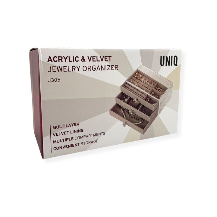 A box for the UNIQ Acrylic Jewellery Organiser with 3 drawers (J305) shows the organiser filled with jewellery. Key features: multilayer design, velvet lining, multiple compartments, and convenient storage. Brand: UNIQ.