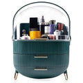 Der UNIQ Retro Makeup Box Organiser in Dark Mint/Dark Green verfügt über zwei geriffelte Schubladen, goldene Griffe und Beine sowie einen durchsichtigen Domdeckel, in dem Sie Ihre Hautpflege- und Make-up-Utensilien ordentlich aufbewahren können.